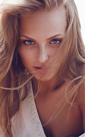 Sexy woman with blue eyes looking into the camera