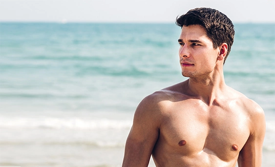 Attractive shirtless man on the beach