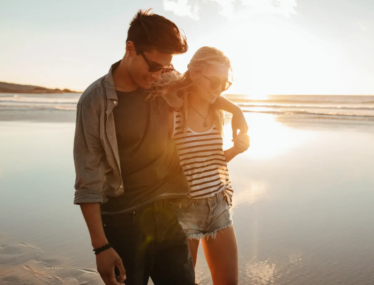 happy couple on beach walk