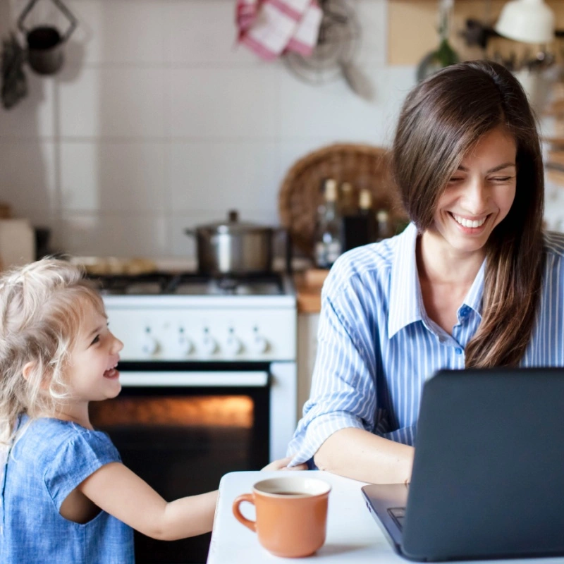 mom working from home with daughter nearby