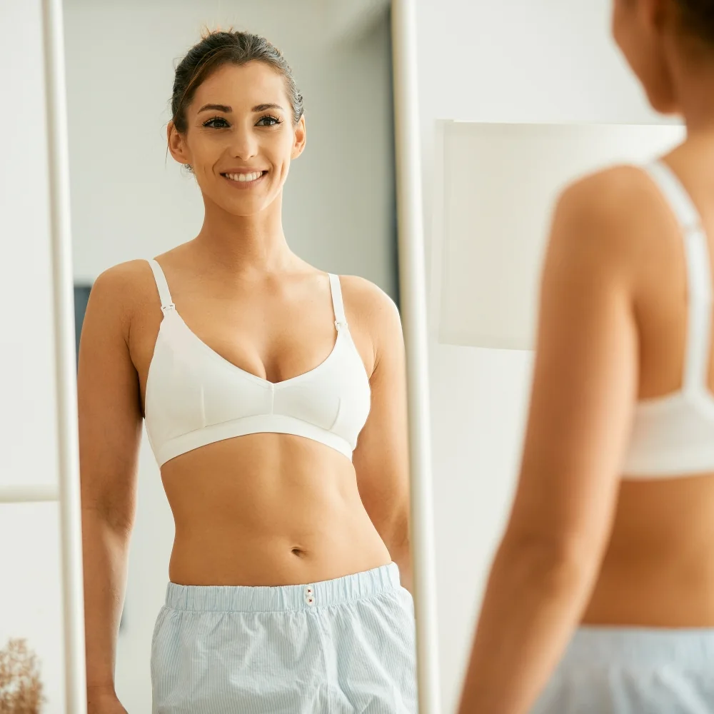 Confident woman looking at herself in the mirror